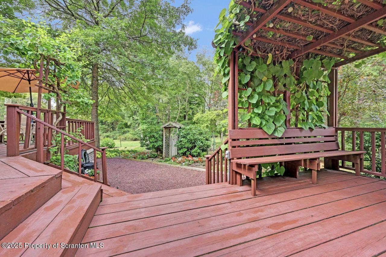 353 Benton Road Dalton, PA 18414 - Photo 50 of 78 a view of a wooden deck with a bench