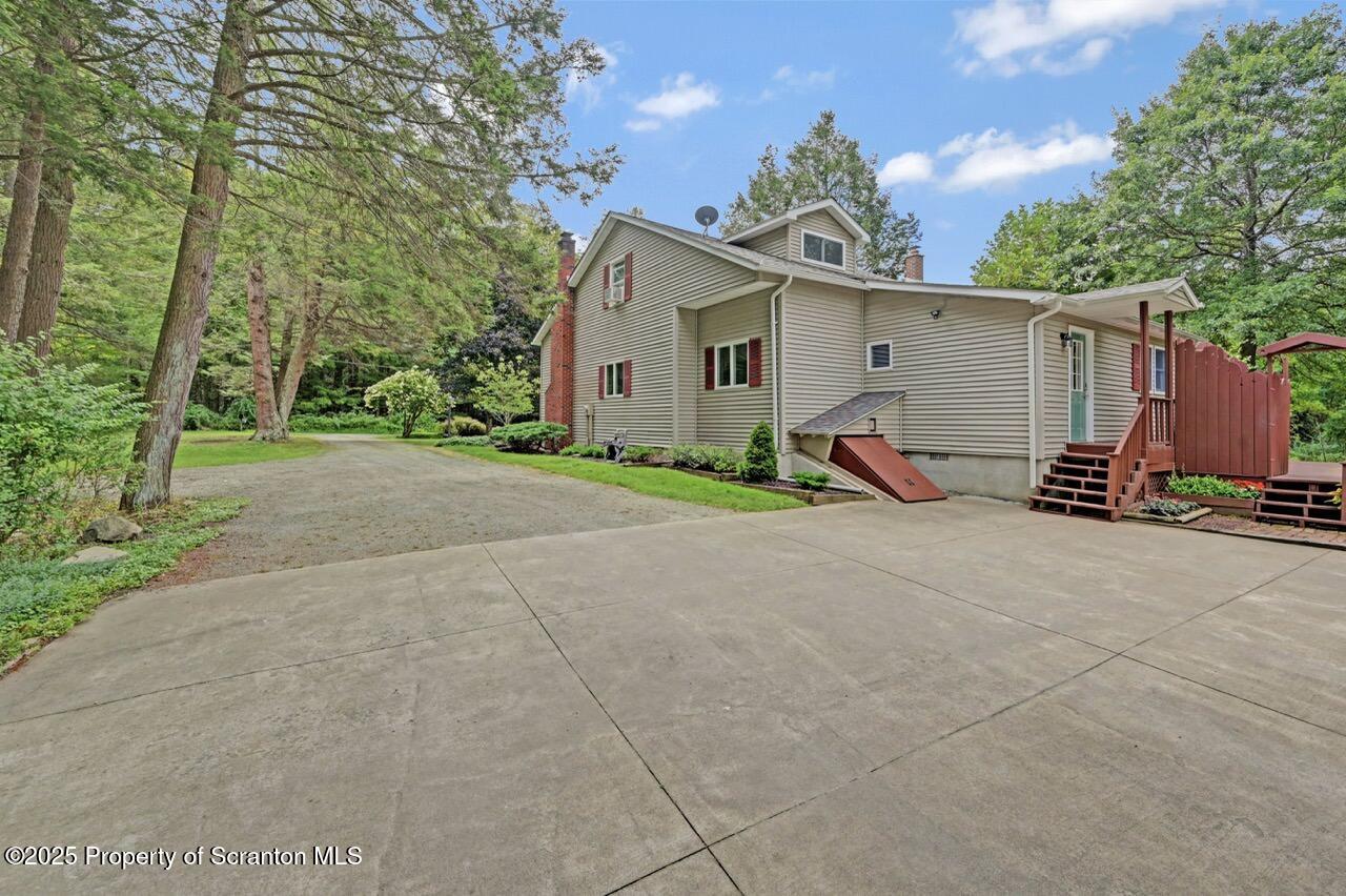 353 Benton Road Dalton, PA 18414 - Photo 55 of 78 a view of a house with backyard and a tree