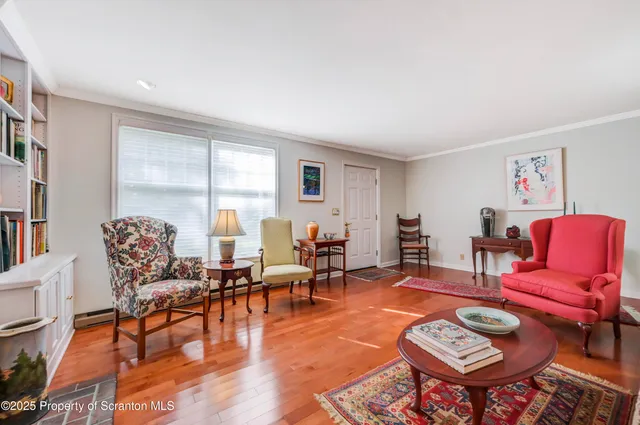 a view of a dining room with furniture wooden floor and a chandelier