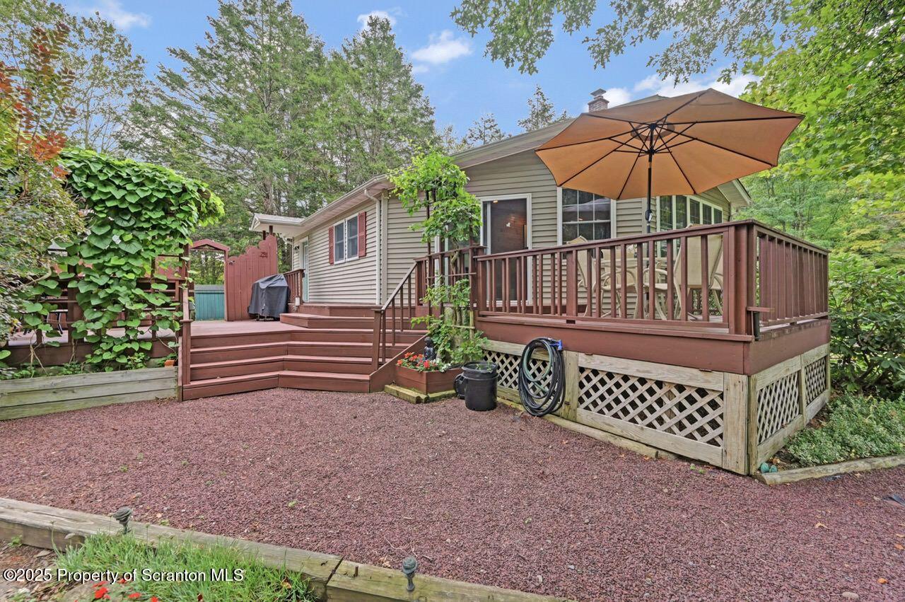 353 Benton Road Dalton, PA 18414 - Photo 72 of 78 a backyard of a house with deck and outdoor seating
