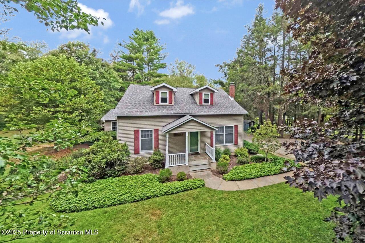 353 Benton Road Dalton, PA 18414 - Photo 73 of 78 a front view of a house with a garden