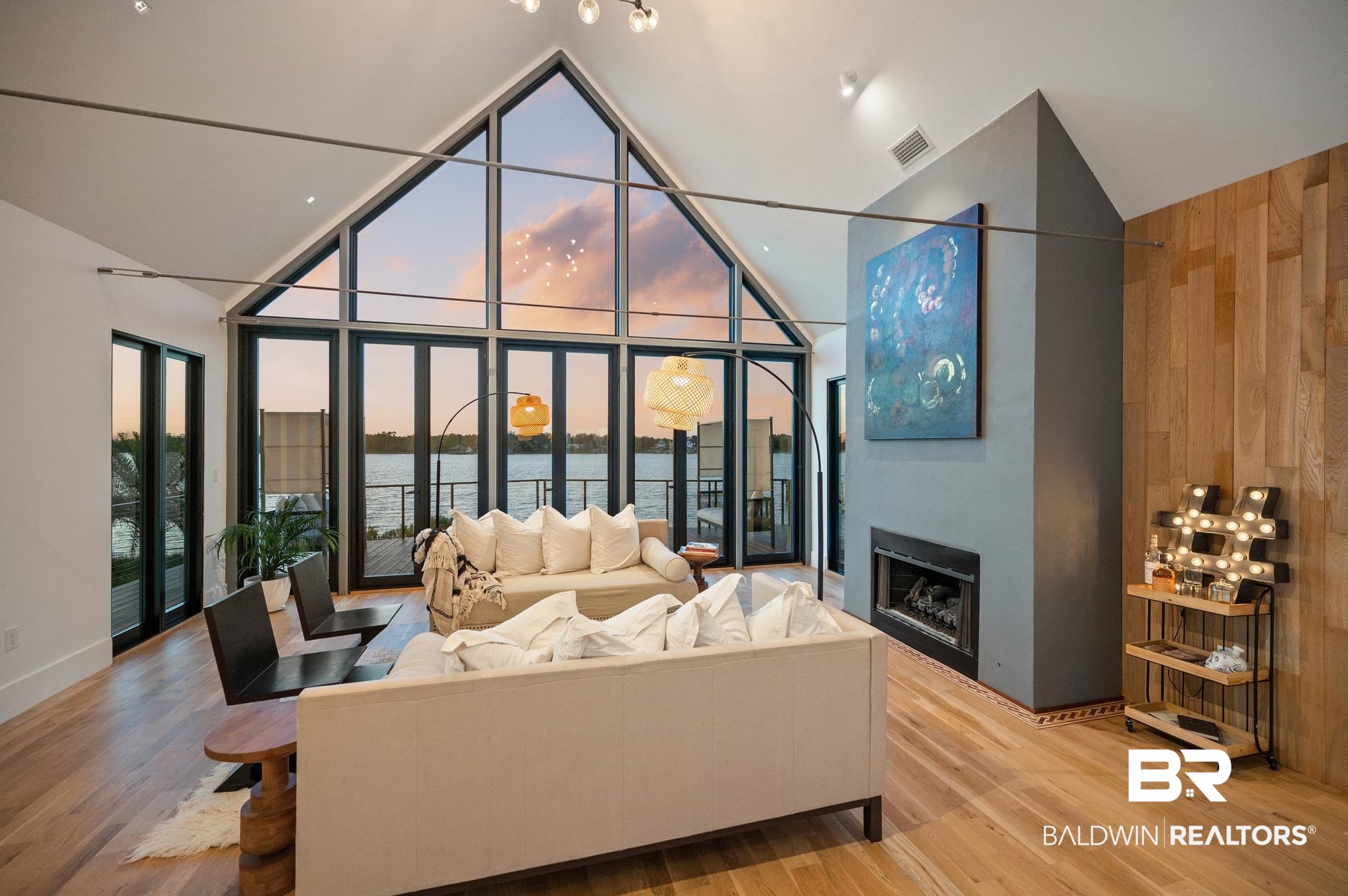 33349 River Road Orange Beach, AL 36561 - Photo 33 of 61 Expansive living area featuring a vaulted ceiling and floor-to-ceiling windows overlooking a body of water