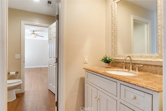 a bathroom with a granite countertop sink and a mirror