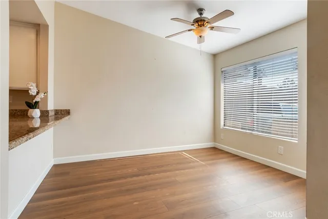 a view of a livingroom with a ceiling fan and window