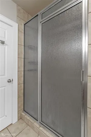 a bathroom with a glass shower door
