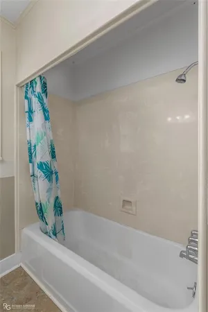 a bathroom with a bathtub and shower