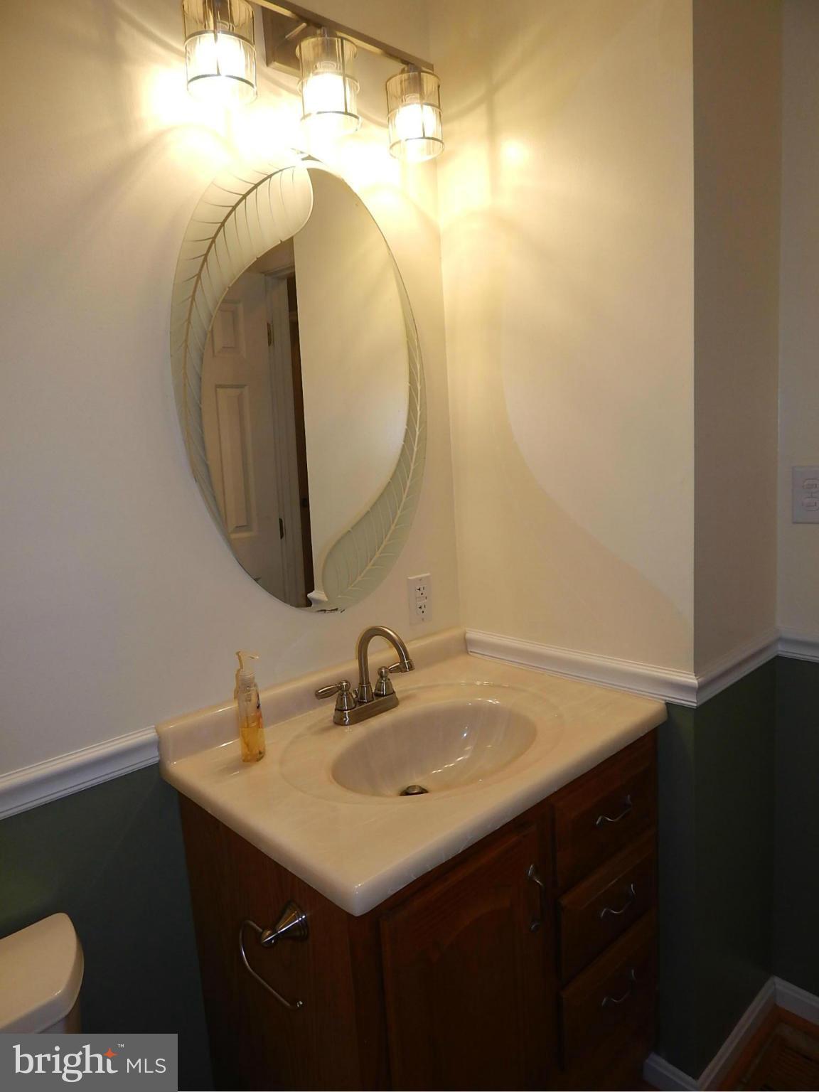 1615 Lottie Fowler Road Prince Frederick, MD 20678 - Photo 13 of 29 a bathroom with a sink vanity and a mirror