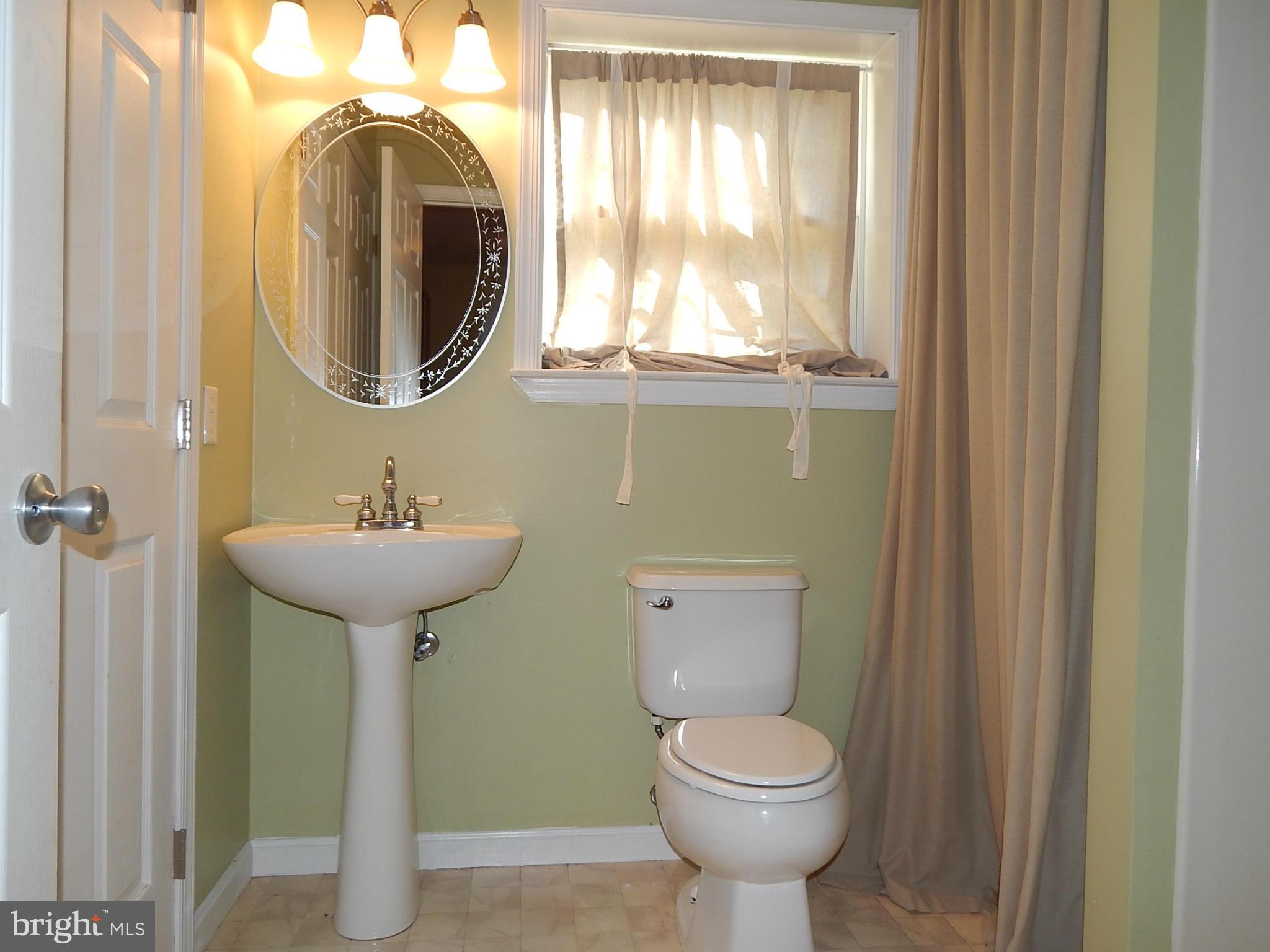 1615 Lottie Fowler Road Prince Frederick, MD 20678 - Photo 17 of 29 a bathroom with a toilet sink and mirror