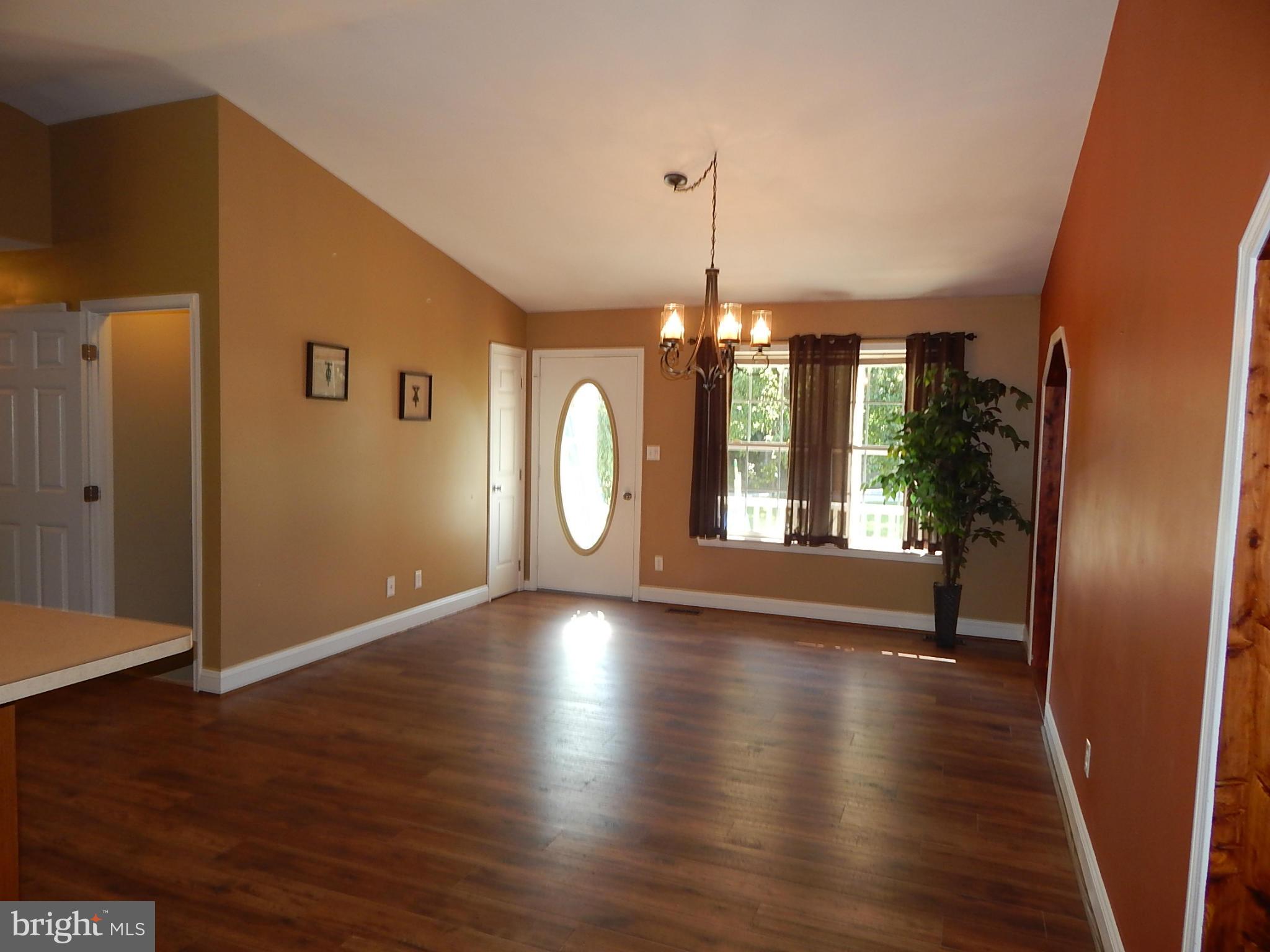 1615 Lottie Fowler Road Prince Frederick, MD 20678 - Photo 7 of 29 a view of an empty room with window and wooden floor