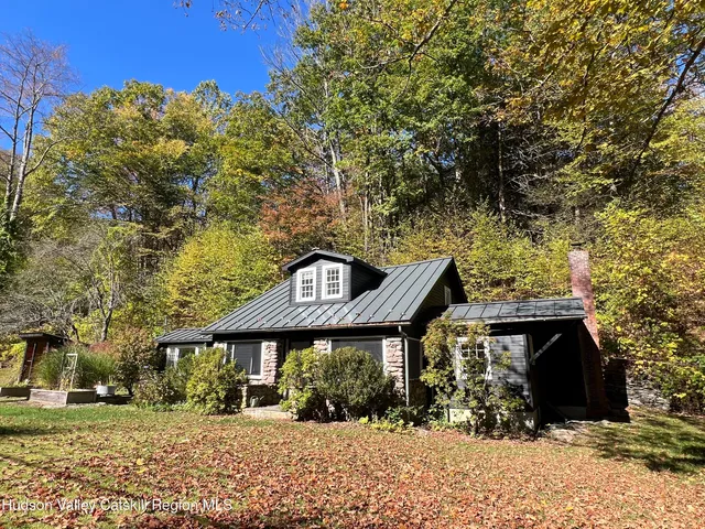 a front view of house with a garden
