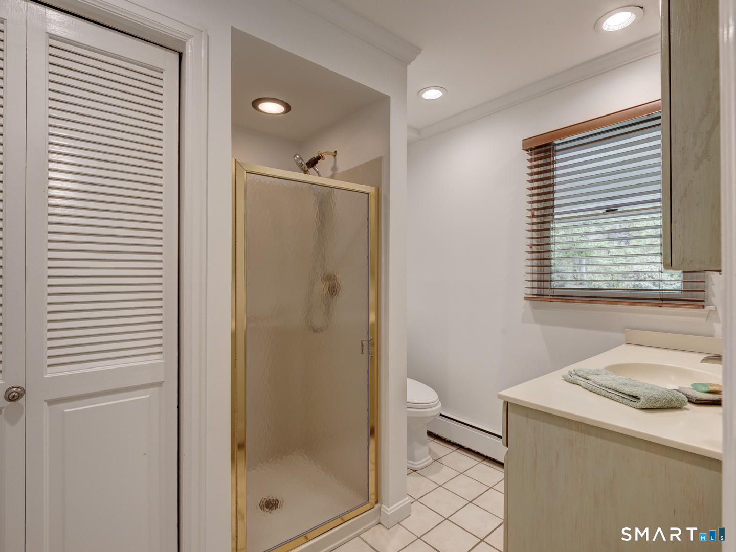 78 Windtree Street Torrington, CT 06790 - Photo 26 of 40 a bathroom with a granite countertop sink a toilet and shower