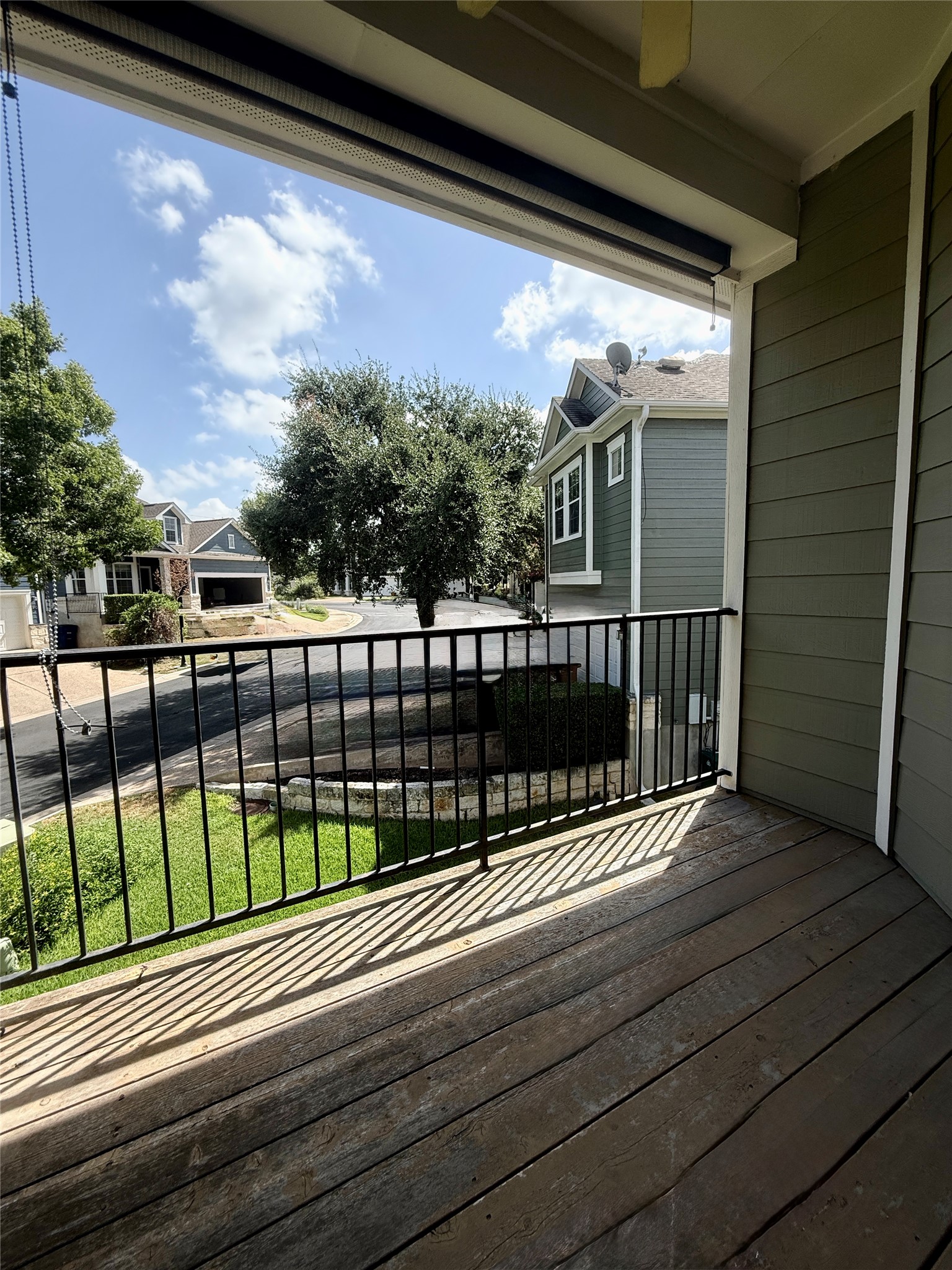 411 West St Elmo Road, Unit 39 Austin, TX 78745 - Photo 21 of 25 An elevated wood balcony overlooks the surrounding neighborhood streets and mature trees.