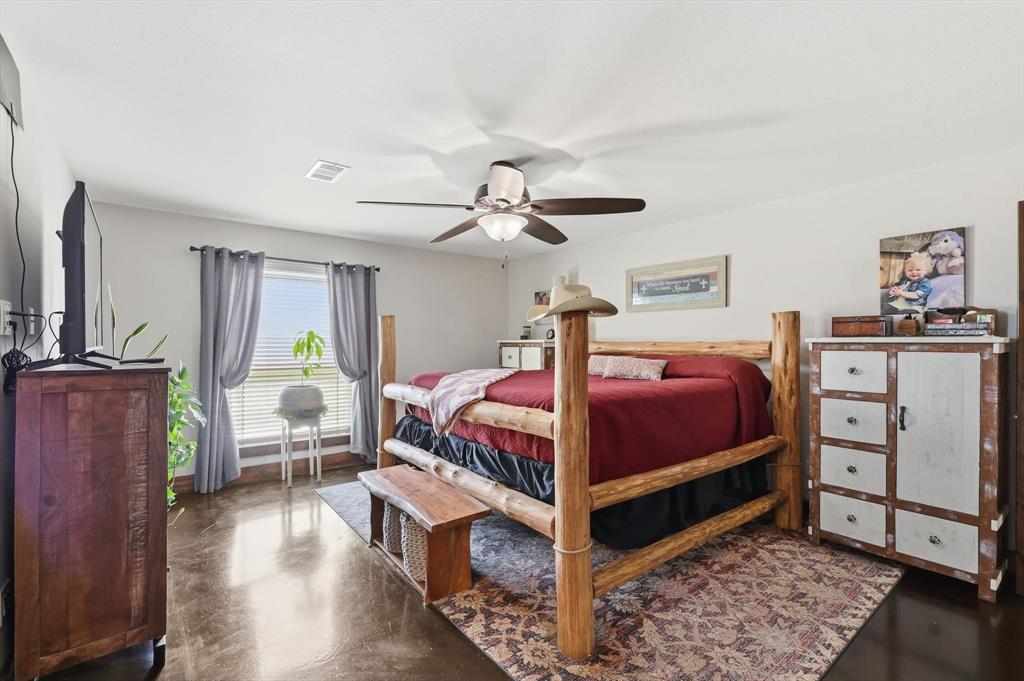 1748 Wilson Road Palmer, TX 75152 - Photo 11 of 40 a bedroom with a bed and a chandelier