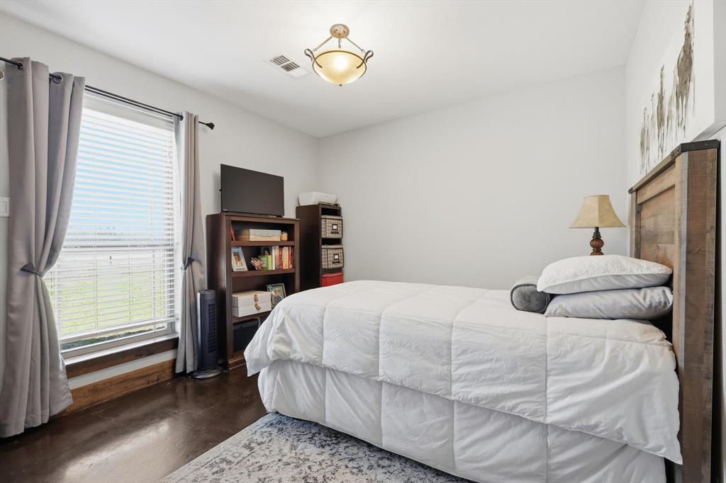 1748 Wilson Road Palmer, TX 75152 - Photo 15 of 40 a bedroom with a bed and a table