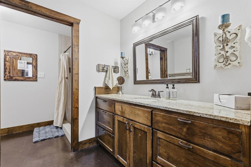 1748 Wilson Road Palmer, TX 75152 - Photo 16 of 40 a bathroom with a granite countertop sink vanity and mirror