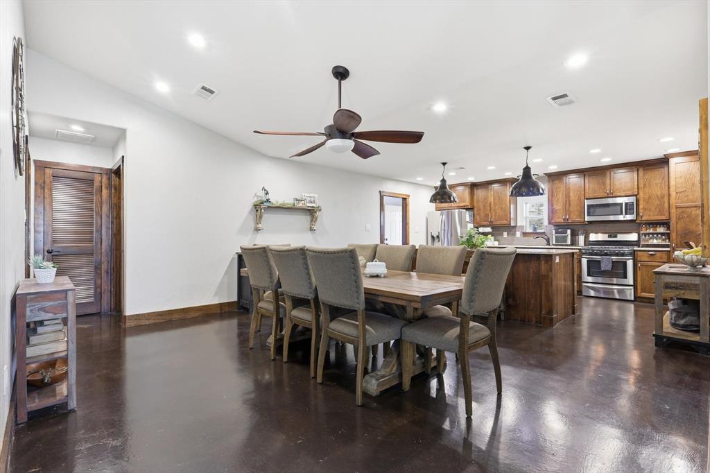 1748 Wilson Road Palmer, TX 75152 - Photo 2 of 40 a view of a dining room with furniture and wooden floor