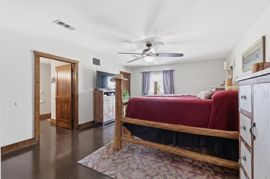 1748 Wilson Road Palmer, TX 75152 - Photo 10 of 40 a large bedroom with a bed and wooden floor