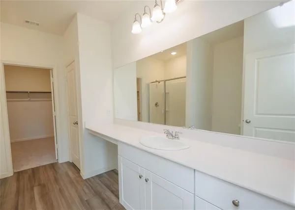 a bathroom with a double vanity sink and mirror