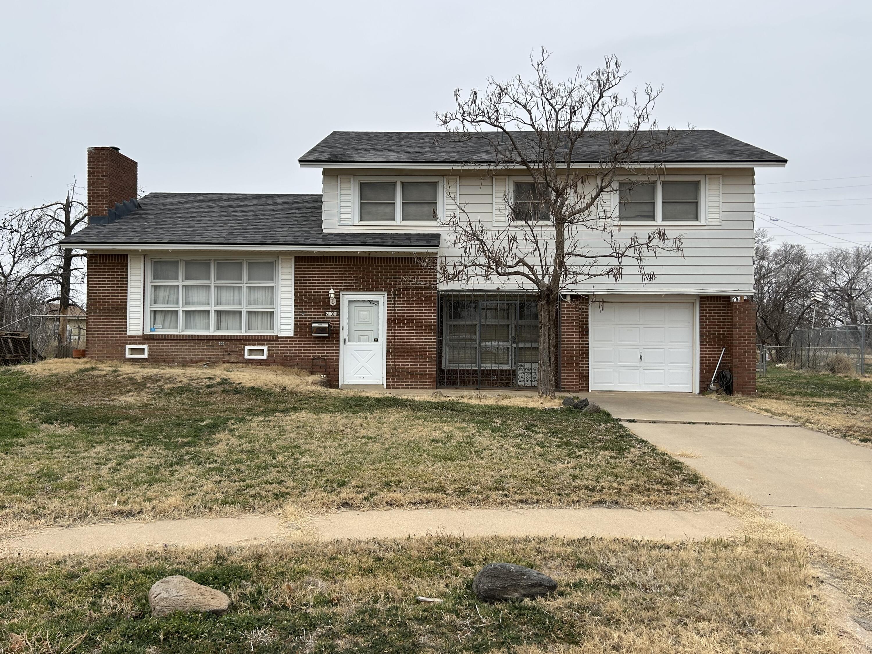2802 Walnut Avenue Lubbock, TX 79404 - Photo 1 of 13 a front view of a house with a yard and garage
