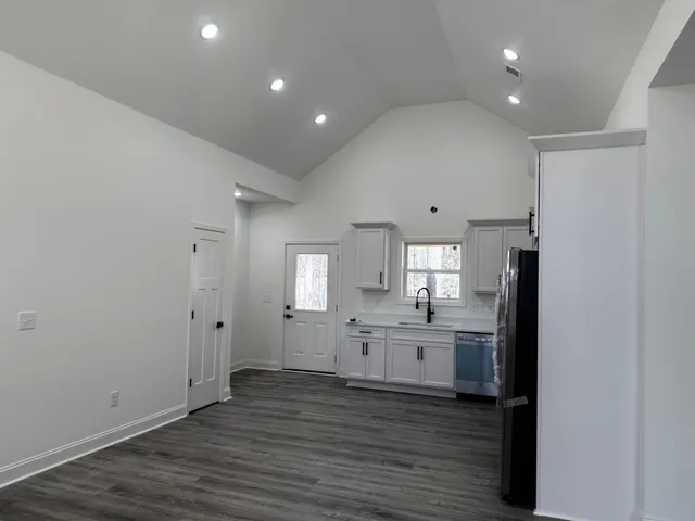 a view of a kitchen with a sink and a refrigerator