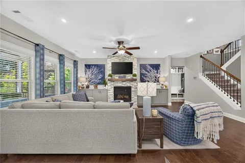 a living room with furniture a fireplace and a chandelier