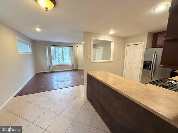 a view of kitchen with sink and refrigerator