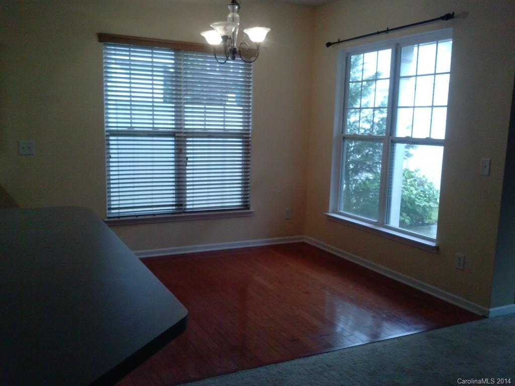 219 Faust Road Davidson, NC 28036 - Photo 2 of 12 an empty room with wooden floor and windows