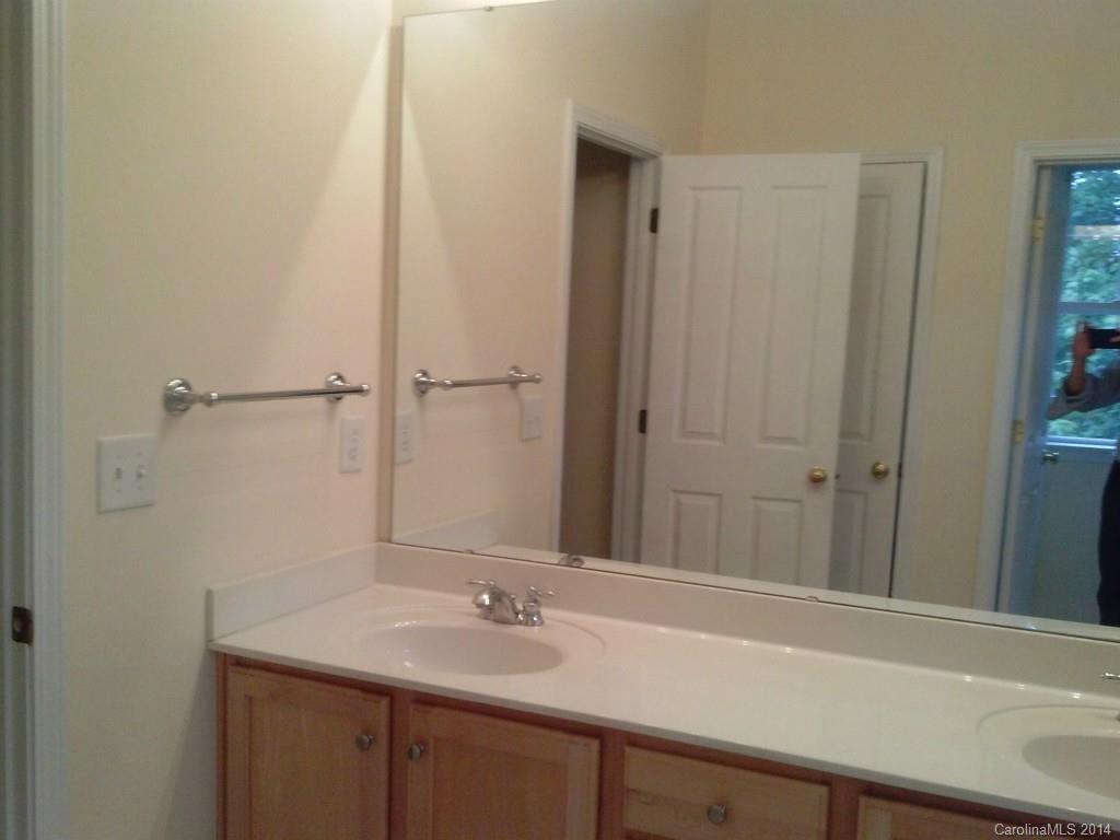 219 Faust Road Davidson, NC 28036 - Photo 8 of 12 a bathroom with a sink and a mirror