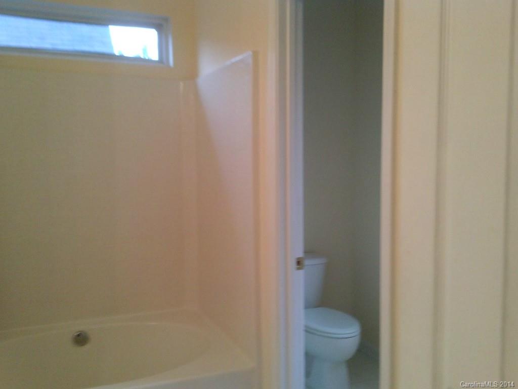 219 Faust Road Davidson, NC 28036 - Photo 9 of 12 a bathroom with a granite countertop toilet and a sink