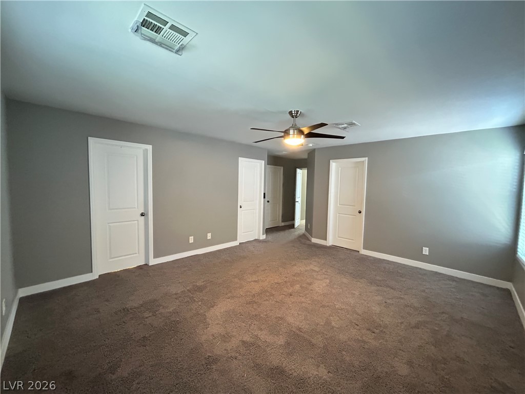 6538 Elm Spring Las Vegas, NV 89148 - Photo 8 of 29 An inviting secondary bedroom, featuring soft carpeting and a contemporary ceiling fan for year-round comfort.
