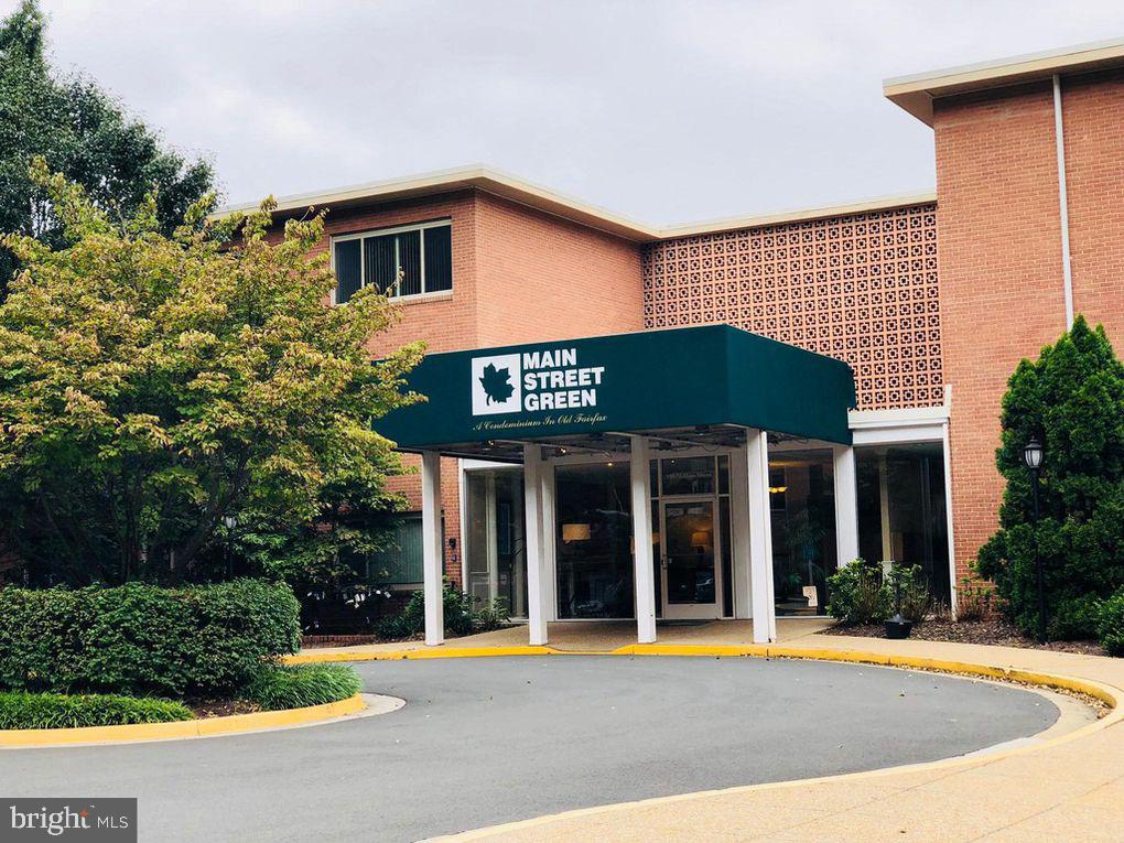 10570 Main Street, Unit 524 Fairfax, VA 22030 - Photo 1 of 19 a front view of a house with a garden