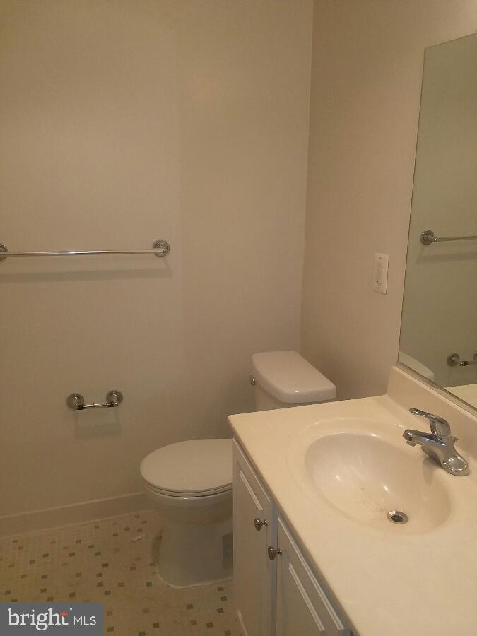 10570 Main Street, Unit 524 Fairfax, VA 22030 - Photo 13 of 19 a bathroom with a sink a toilet and a mirror