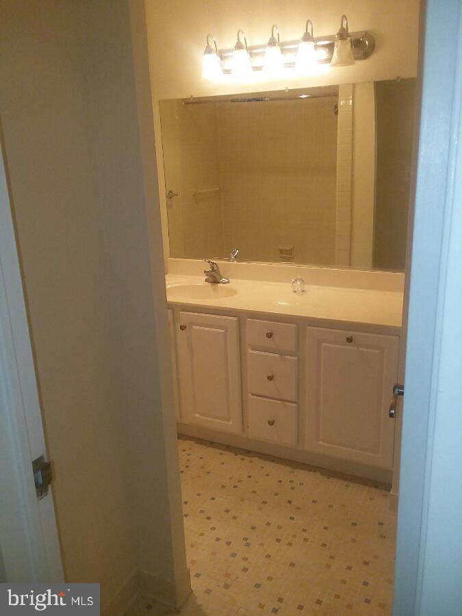 10570 Main Street, Unit 524 Fairfax, VA 22030 - Photo 14 of 19 a bathroom with a sink and mirror