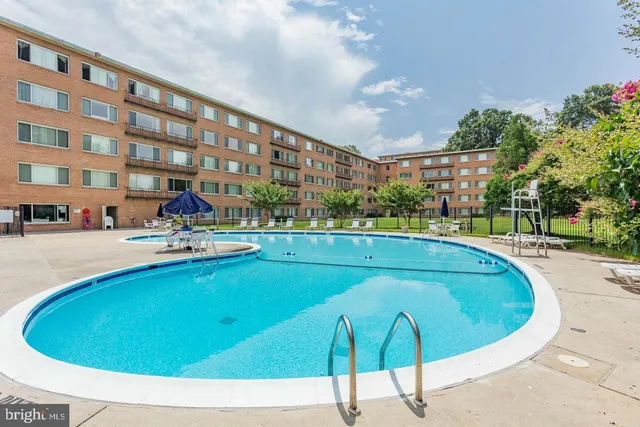 a view of a swimming pool with outdoor seating