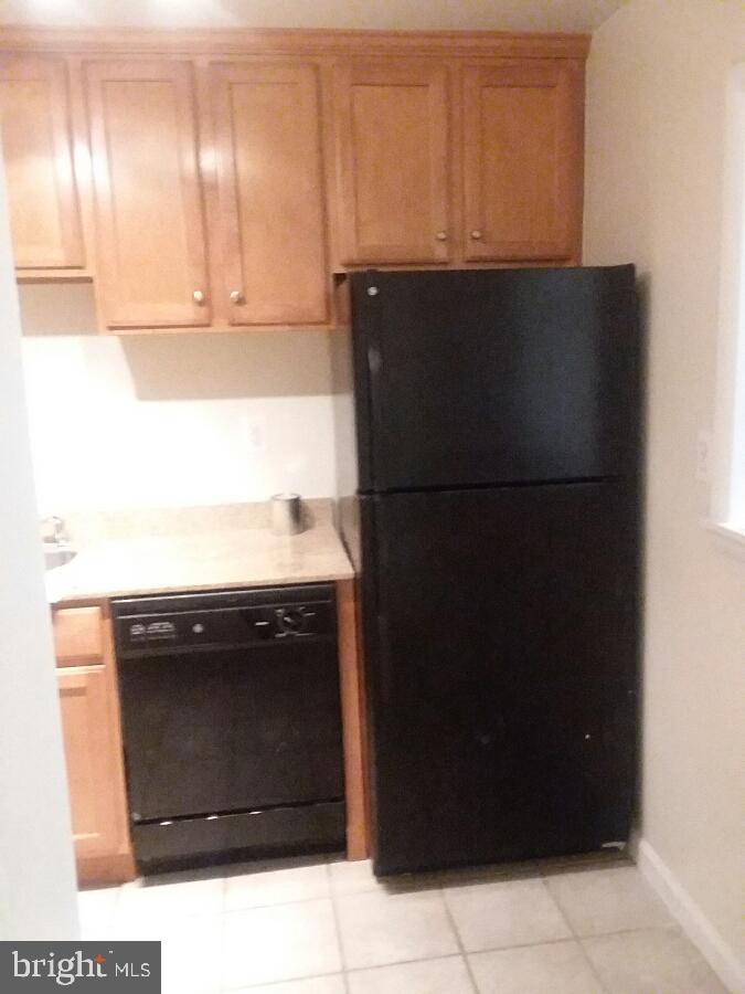 10570 Main Street, Unit 524 Fairfax, VA 22030 - Photo 8 of 19 a kitchen with a refrigerator and cabinets