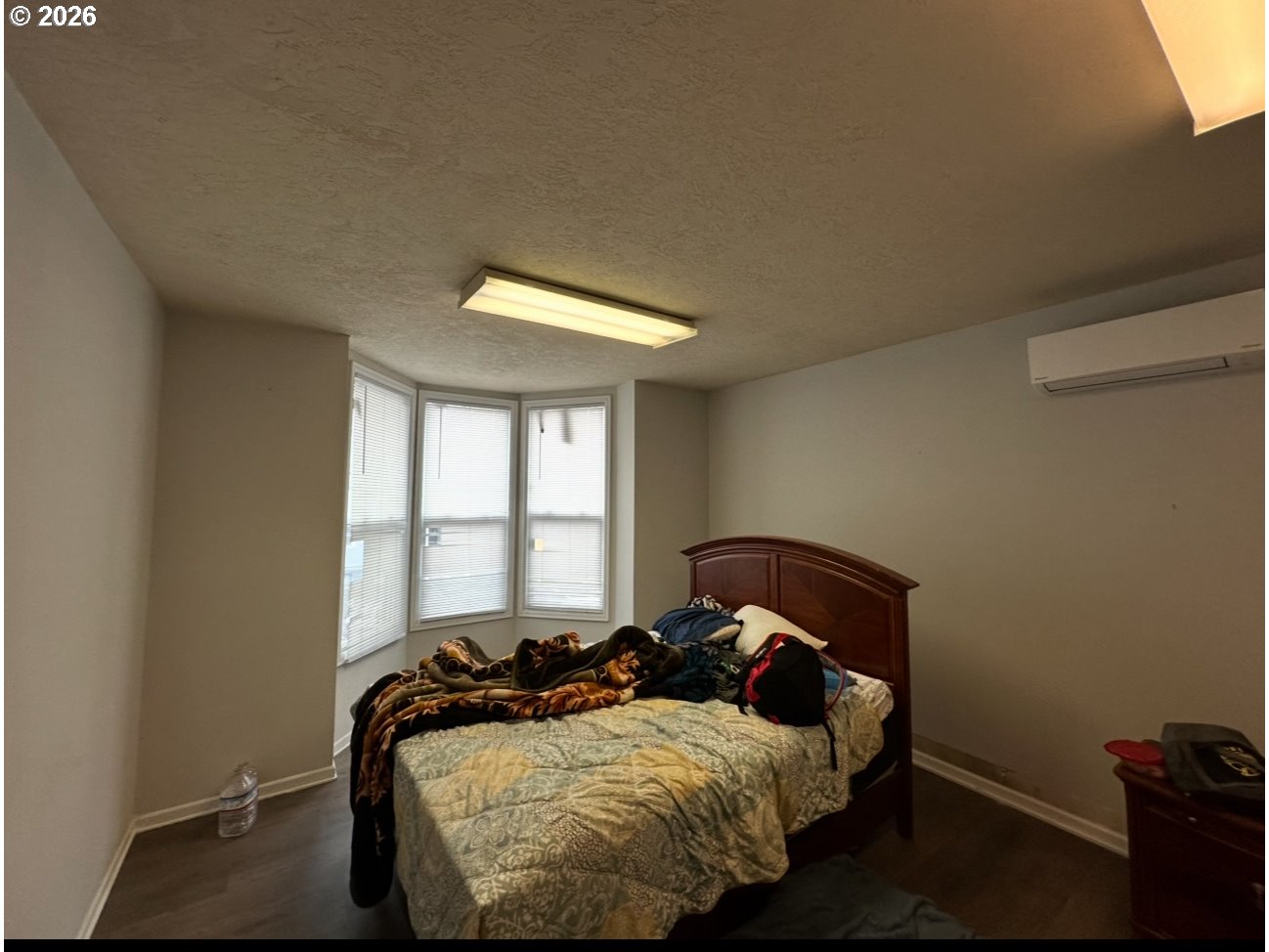 1326 Southwest 12th Avenue Portland, OR 97201 - Photo 2 of 11 a bedroom with a bed and window