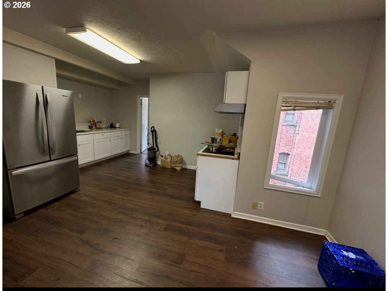 1326 Southwest 12th Avenue Portland, OR 97201 - Photo 4 of 11 a kitchen with wooden floors and refrigerator