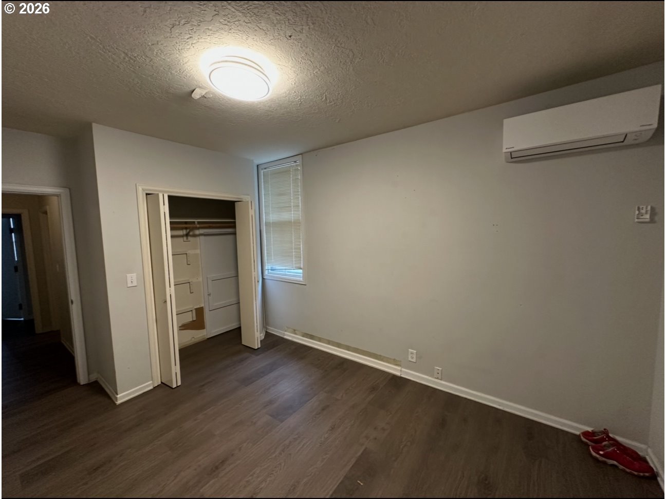 1326 Southwest 12th Avenue Portland, OR 97201 - Photo 5 of 11 an empty room with wooden floor and closet