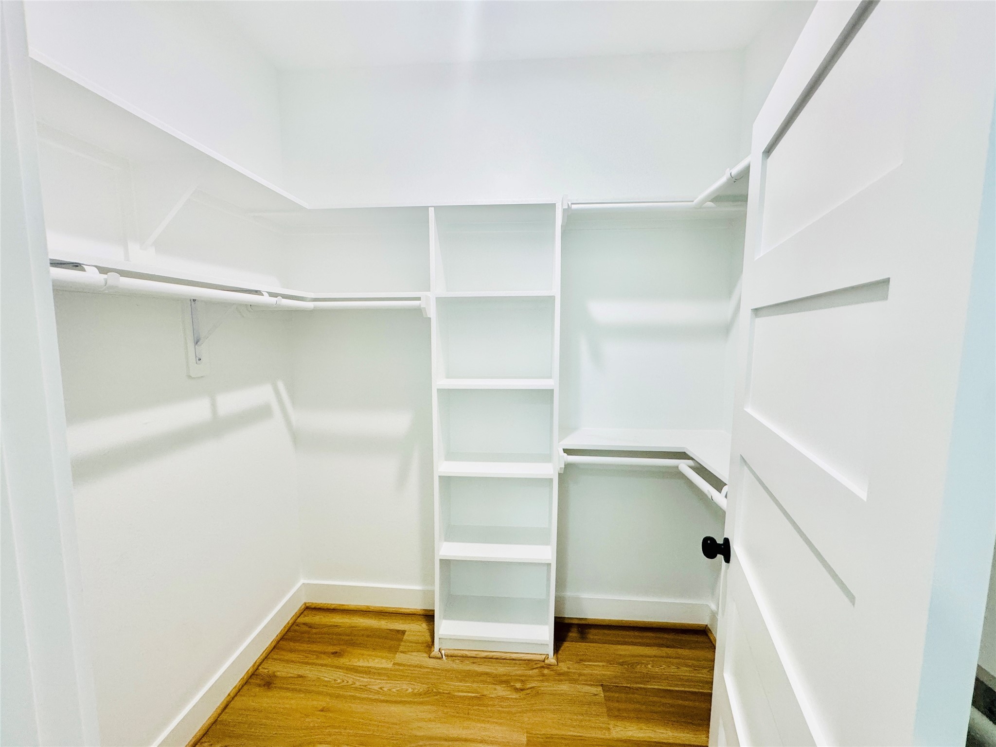 9362 Starfire Lane Houston, TX 77036 - Photo 9 of 11 a view of walk in closet with empty racks