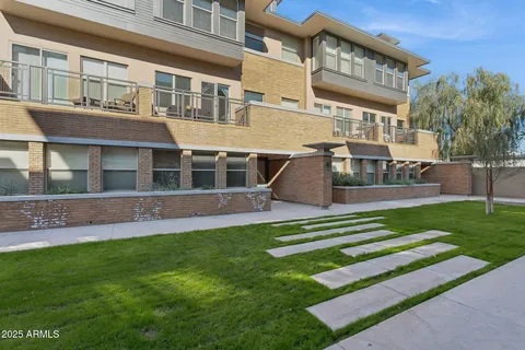 a front view of a building with a yard