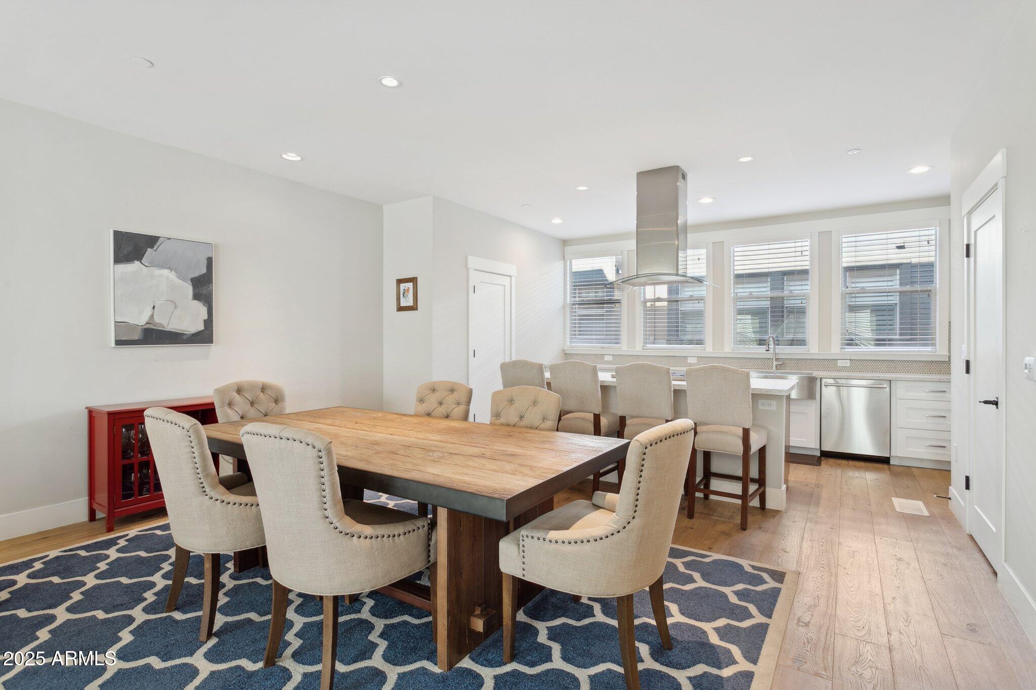 1400 East Bethany Home Road, Unit 22 Phoenix, AZ 85014 - Photo 9 of 46 a view of a dining room with furniture and wooden floor
