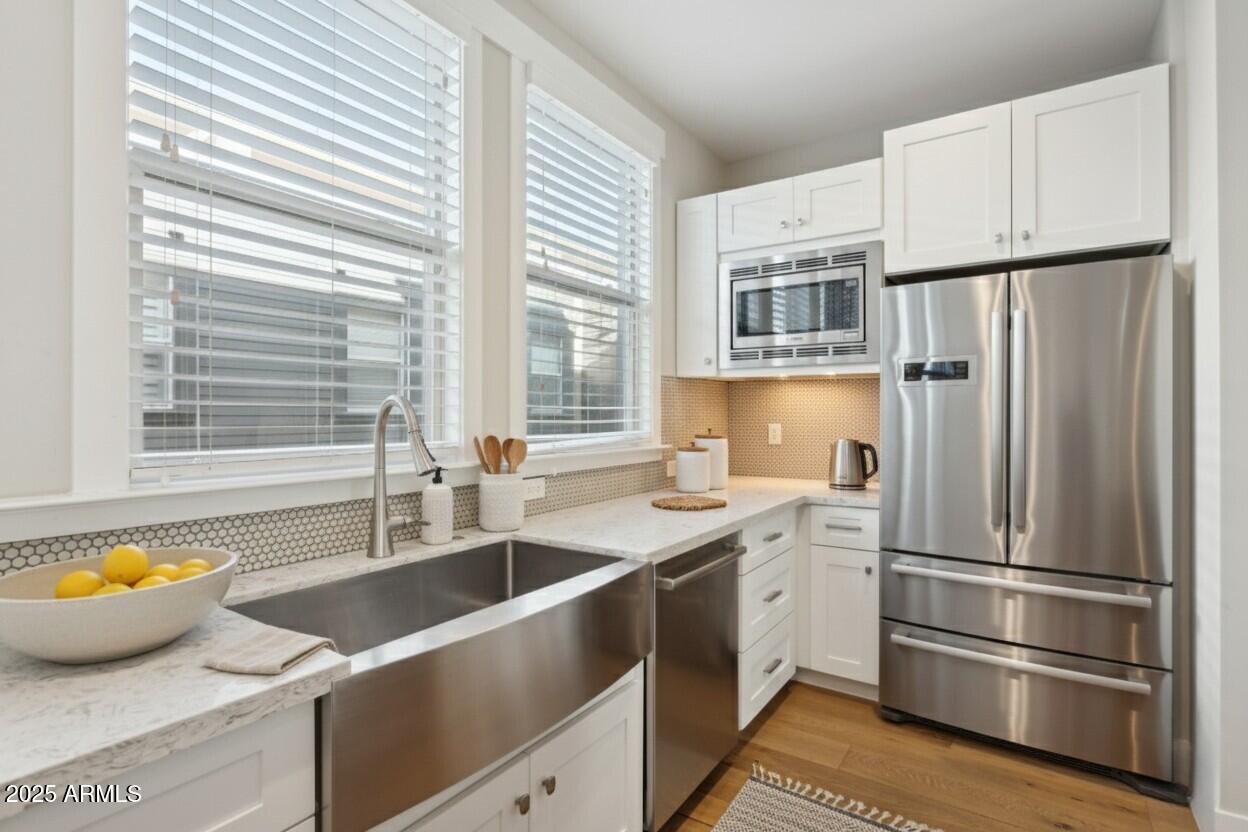 1400 East Bethany Home Road, Unit 22 Phoenix, AZ 85014 - Photo 12 of 46 a kitchen with stainless steel appliances a refrigerator sink and cabinets