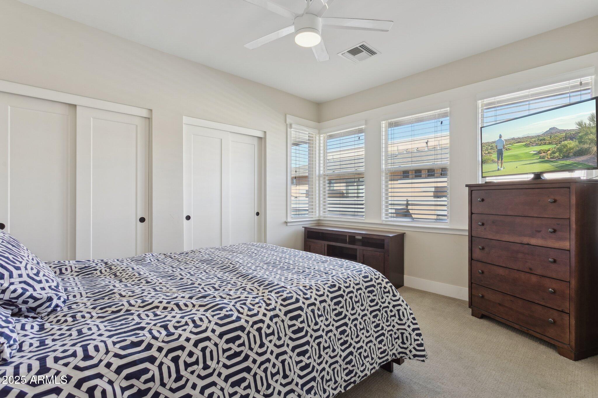 1400 East Bethany Home Road, Unit 22 Phoenix, AZ 85014 - Photo 21 of 46 a bedroom with a bed and a dresser
