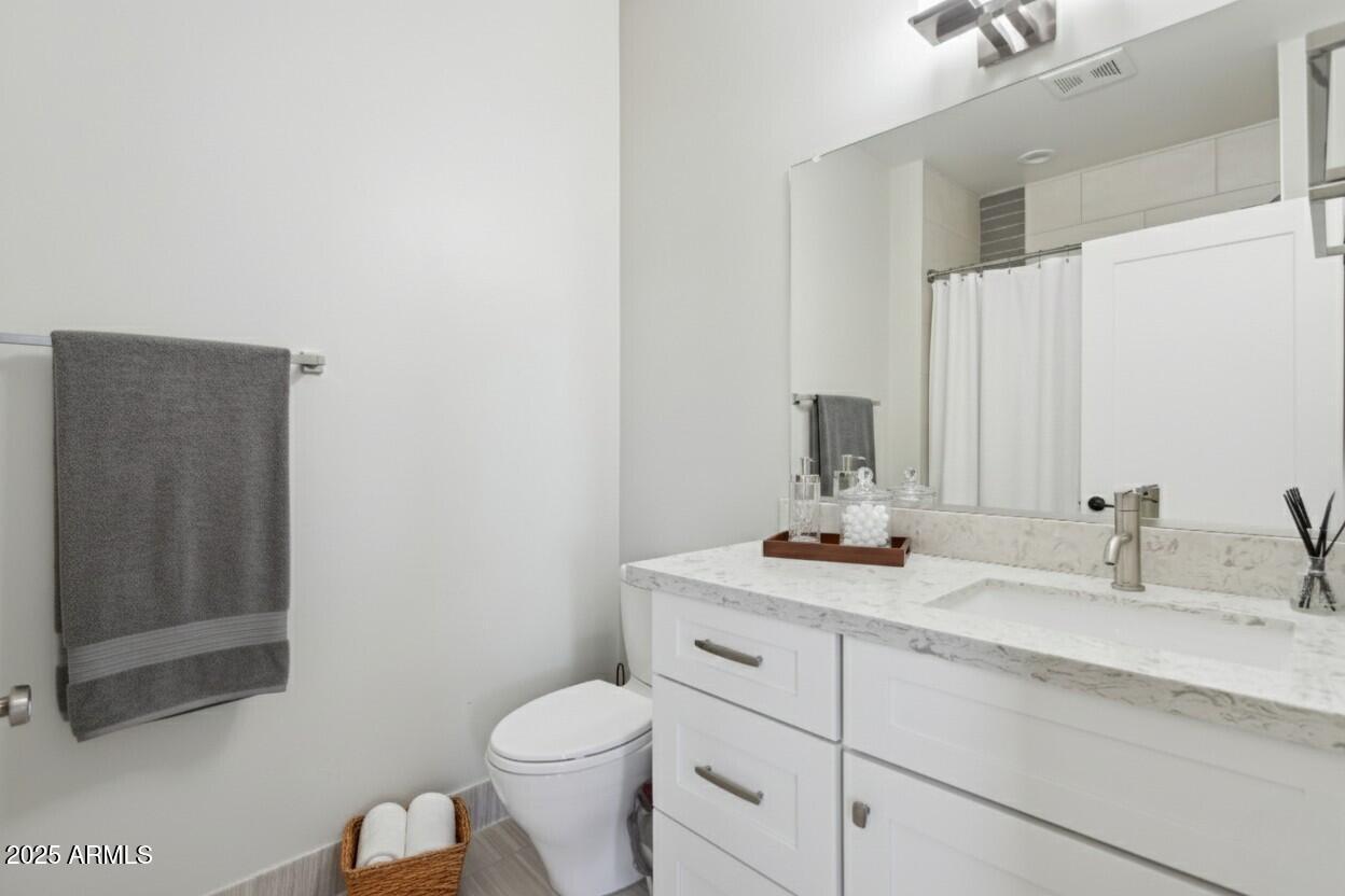 1400 East Bethany Home Road, Unit 22 Phoenix, AZ 85014 - Photo 22 of 46 a bathroom with a sink toilet and mirror