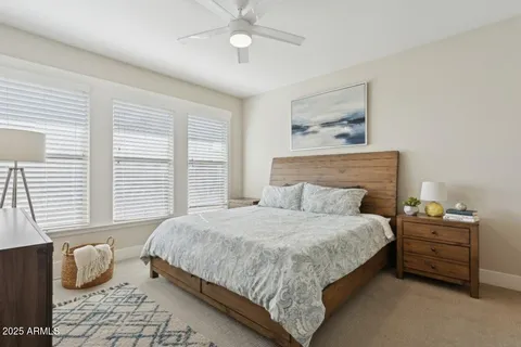 a living room with furniture and a ceiling fan