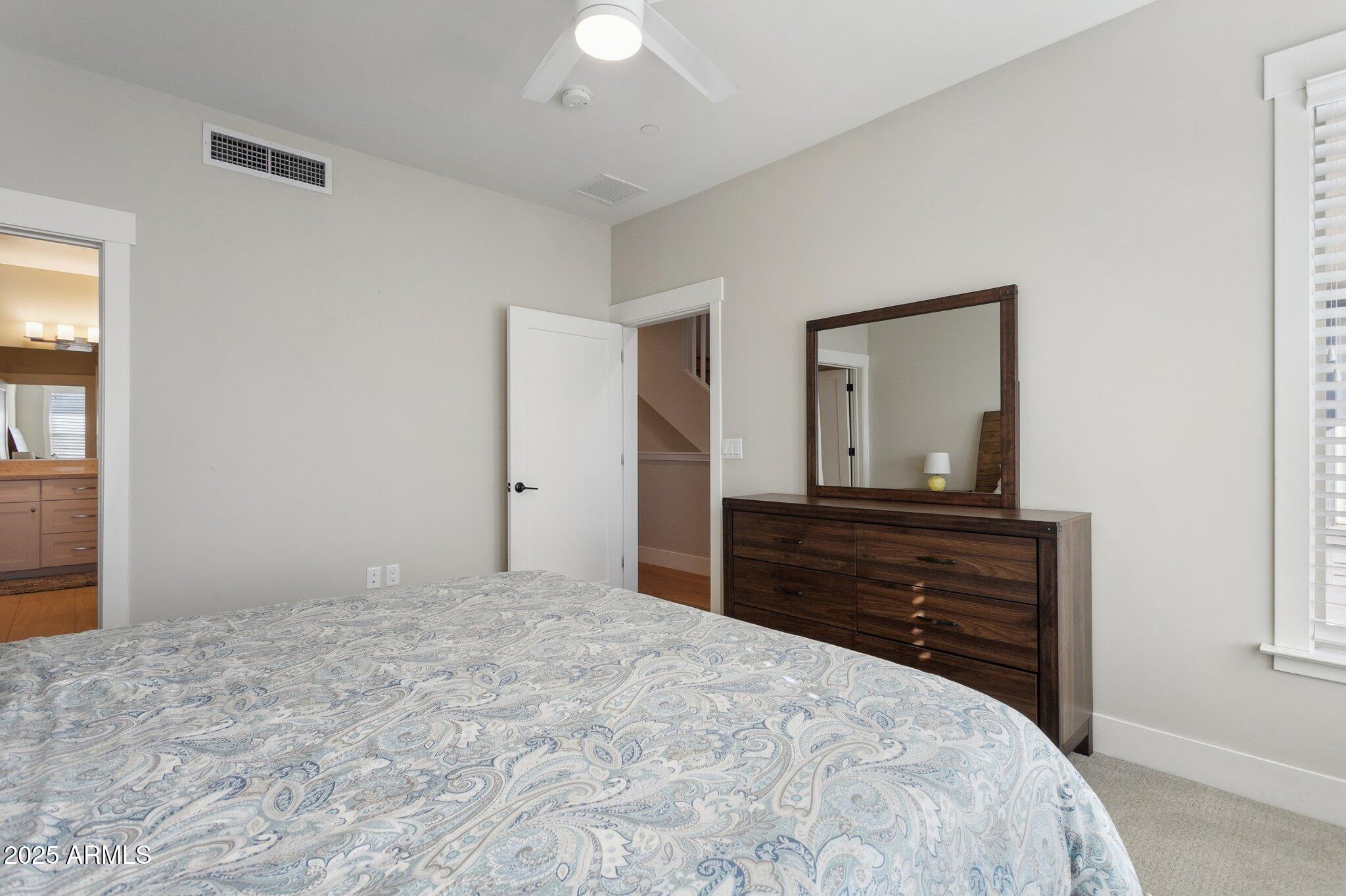 1400 East Bethany Home Road, Unit 22 Phoenix, AZ 85014 - Photo 25 of 46 a bedroom with a bed and a mirror on dresser