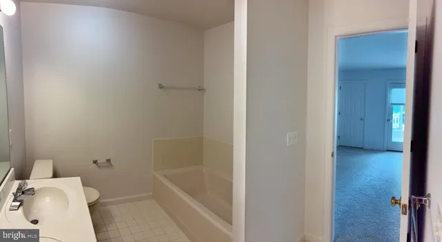 a bathroom with a sink mirror and toilet