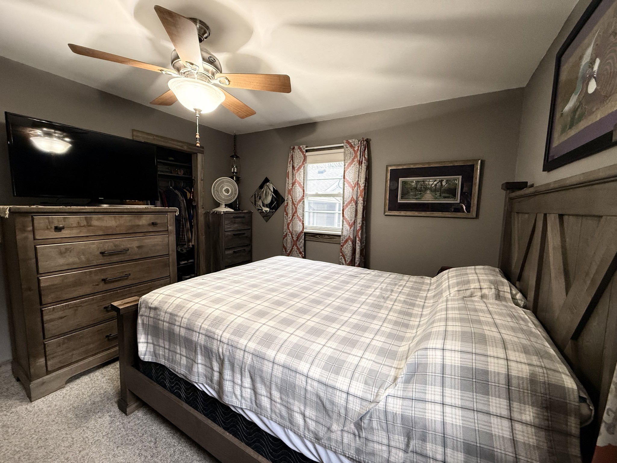 111 Gentry Street Tullahoma, TN 37388 - Photo 34 of 66 a bedroom with a bed a dresser and flat screen tv