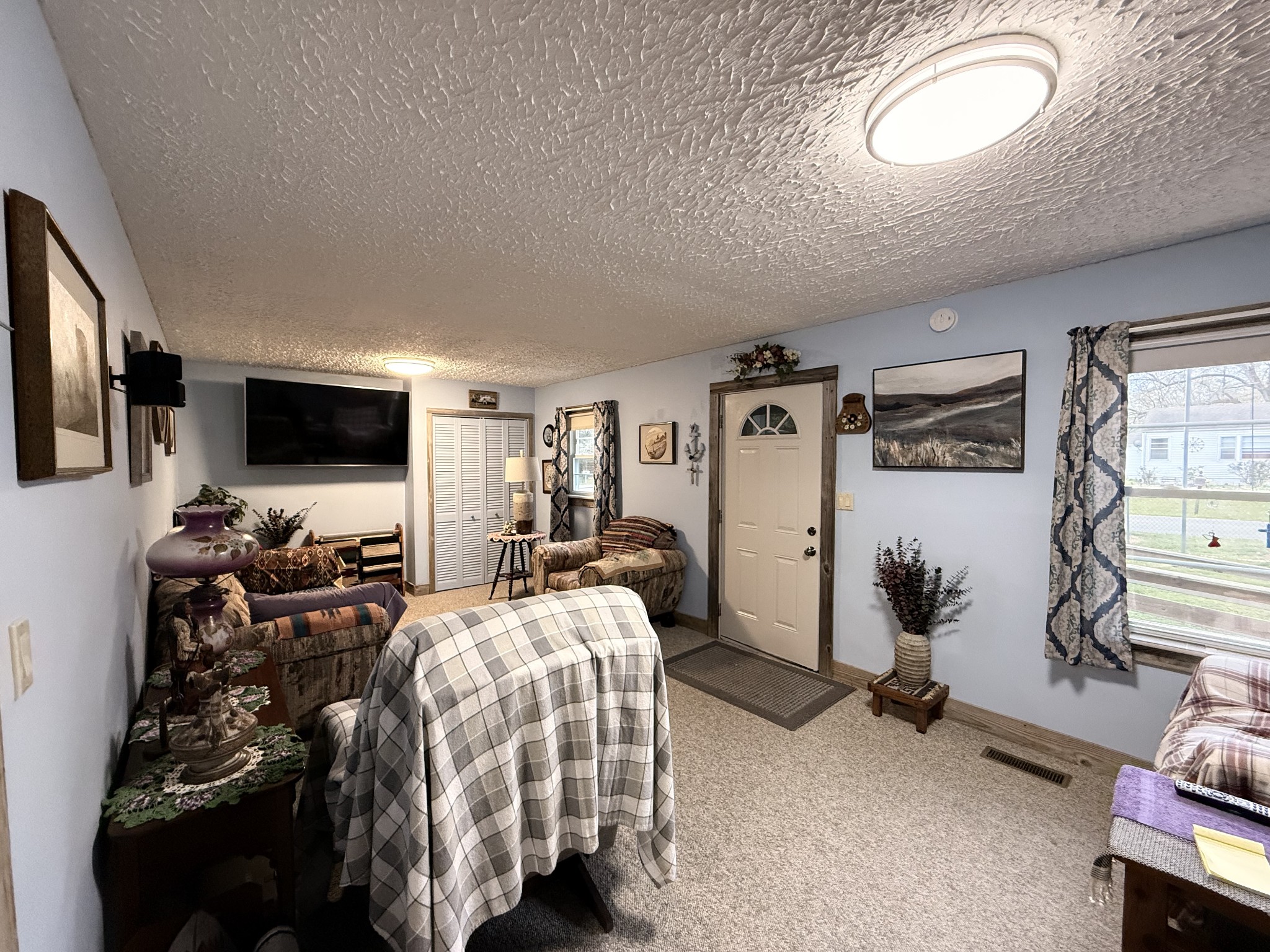 111 Gentry Street Tullahoma, TN 37388 - Photo 40 of 66 a bedroom with furniture a flat screen tv and a large window