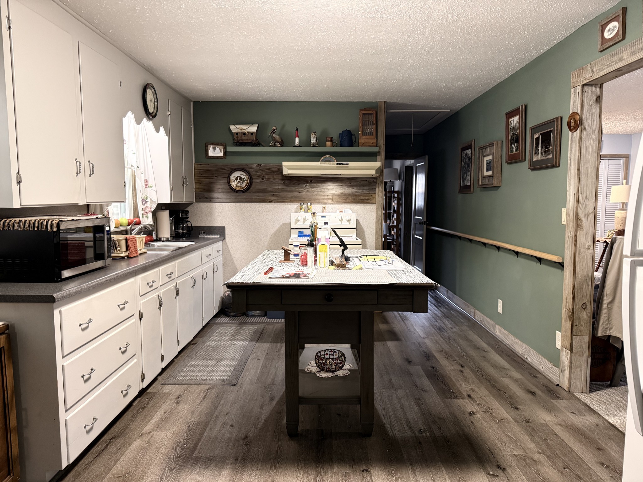111 Gentry Street Tullahoma, TN 37388 - Photo 52 of 66 a kitchen with stainless steel appliances a sink cabinets and wooden floor